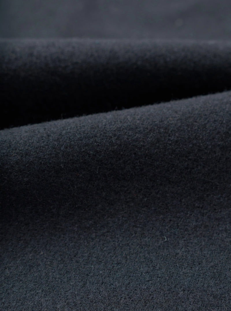Close-up swatch view displaying the fabric weave of the Dark Navy Dublin Wool Mix Oxford Pant. The shot fills the frame, showcasing the fine dark navy heathered texture and soft wool-blend weave of the trousers.