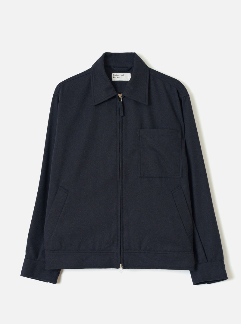 Front view of the Dark Navy Dublin Wool Mix Rose Bowl Jacket worn by a model against a plain studio background. The boxy jacket features a full front zip, oversized collar, large chest patch pocket, and dark navy wool-blend fabric.