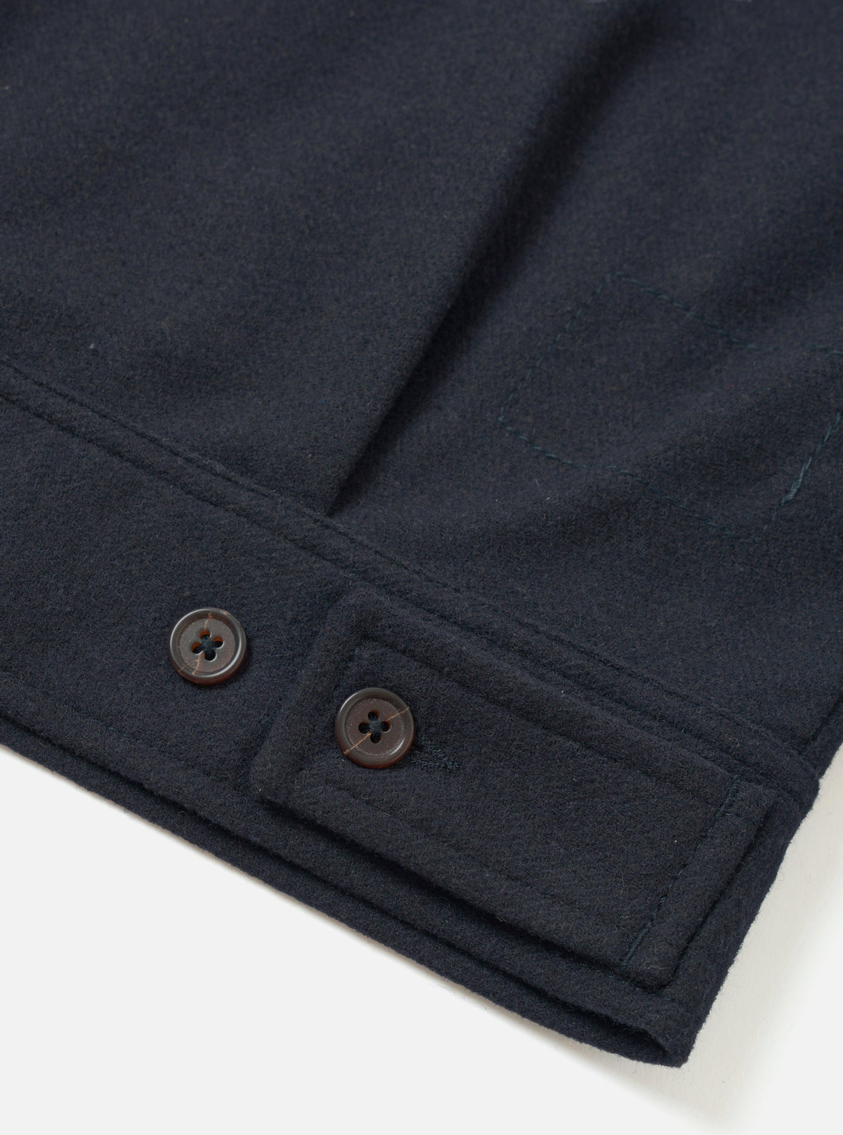 A detailed back view of the Dark Navy Dublin Wool Mix Rose Bowl Jacket set against a plain off-white background. The image highlights the clean rear hem, shoulder seam construction, and dark wool fabric texture.