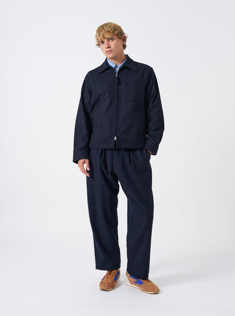 A male model wears the Dark Navy Dublin Wool Mix Rose Bowl Jacket buttoned up over a shirt, standing against a neutral studio backdrop. The full-length shot showcases the garment's fit and casual silhouette.