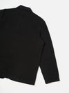 Back view of the Black Dexter Twill OG Bakers Chore Jacket displayed flat against a plain off-white background. The shot highlights the clean back paneling, shoulder seams, and durable black organic cotton twill construction.
