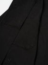 Interior detail view of the Black Dexter Twill OG Bakers Chore Jacket set against a neutral white backdrop. The image showcases the inside hip pocket, interior chest pocket, shoulder lining, and fine seam construction.