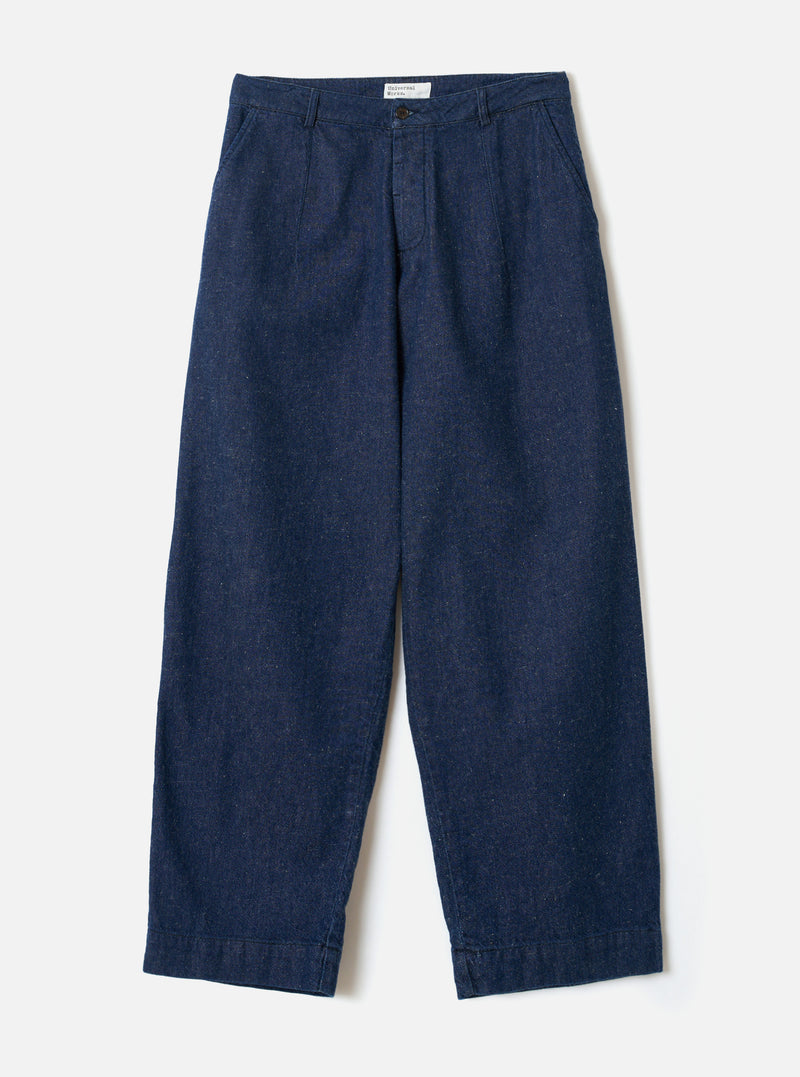 Front view of the Indigo Future Denim Grad Chino displayed against a clean off-white background. The image shows the fixed waistband with belt loops, zip fly, front pockets, and loose tapered legs.