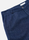 Detailed close-up view of the Indigo Future Denim Grad Chino set against a white studio background, highlighting the ticket pocket construction, belt loops, and organic denim surface texture.