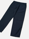 Rear view of the Navy Slub Sateen Utility Pant displayed against a plain off-white background. The image highlights the relaxed tapered fit, rear patch pockets, and textured navy cotton slub sateen fabric.
