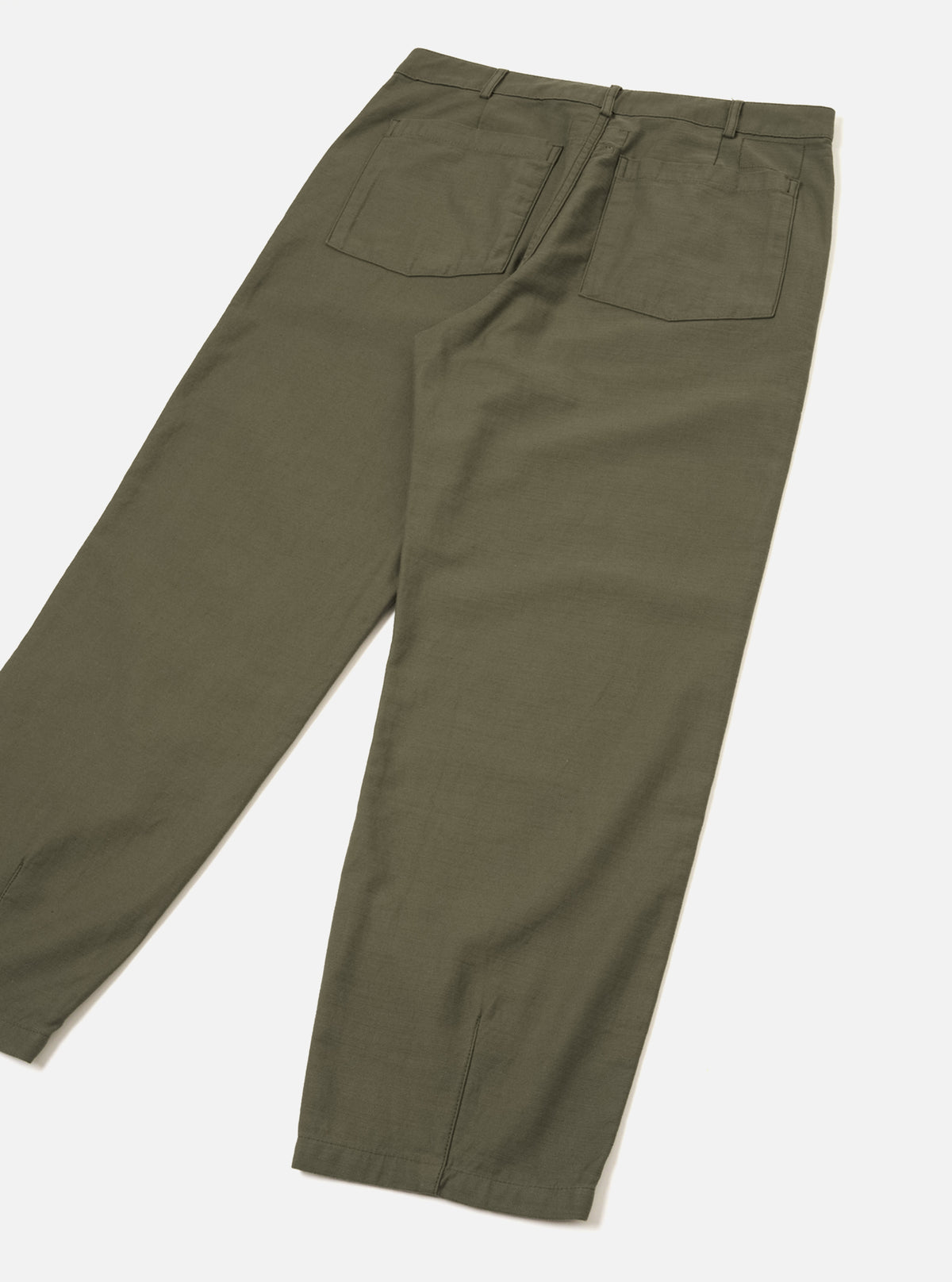 A back view of the Olive Slub Sateen Utility Pant presented against a clean off-white background. The image details the rear patch pockets, waistband, hem darts, and dark olive green slub sateen cotton texture.