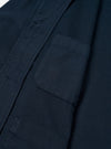 A close-up detail shot of the Navy Slub Sateen Ives Jacket against an off-white background, highlighting the collar structure, contrast buttons, front chest patch pocket, and slub sateen cotton fabric weave.