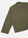 Back view of the Olive Slub Sateen Ives Jacket displayed against a plain neutral background. The shot highlights the loose boxy fit, straight hemline, rear patch pocket, and rich olive green cotton fabric.