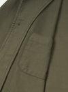 Detailed close-up view of the Olive Slub Sateen Ives Jacket on a neutral studio background, focusing on the spread collar, dark front buttons, topstitching, and upper front patch pocket details.