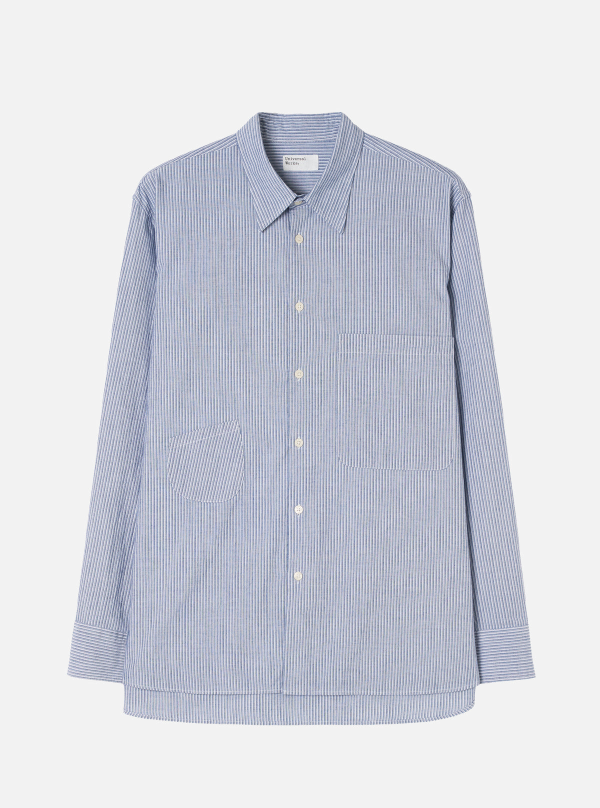 Front view of the Blue Montgomery Stripe Station Shirt displayed against a plain off-white background. The shot highlights the vertical blue stripe pattern, classic point collar, full front button placket, and dual chest patch pockets.