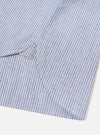 Close-up detail shot of the Blue Montgomery Stripe Station Shirt against a neutral backdrop. The image emphasizes the fine woven cotton stripe texture, precise stitching along the chest pocket, and high-quality front button closures.