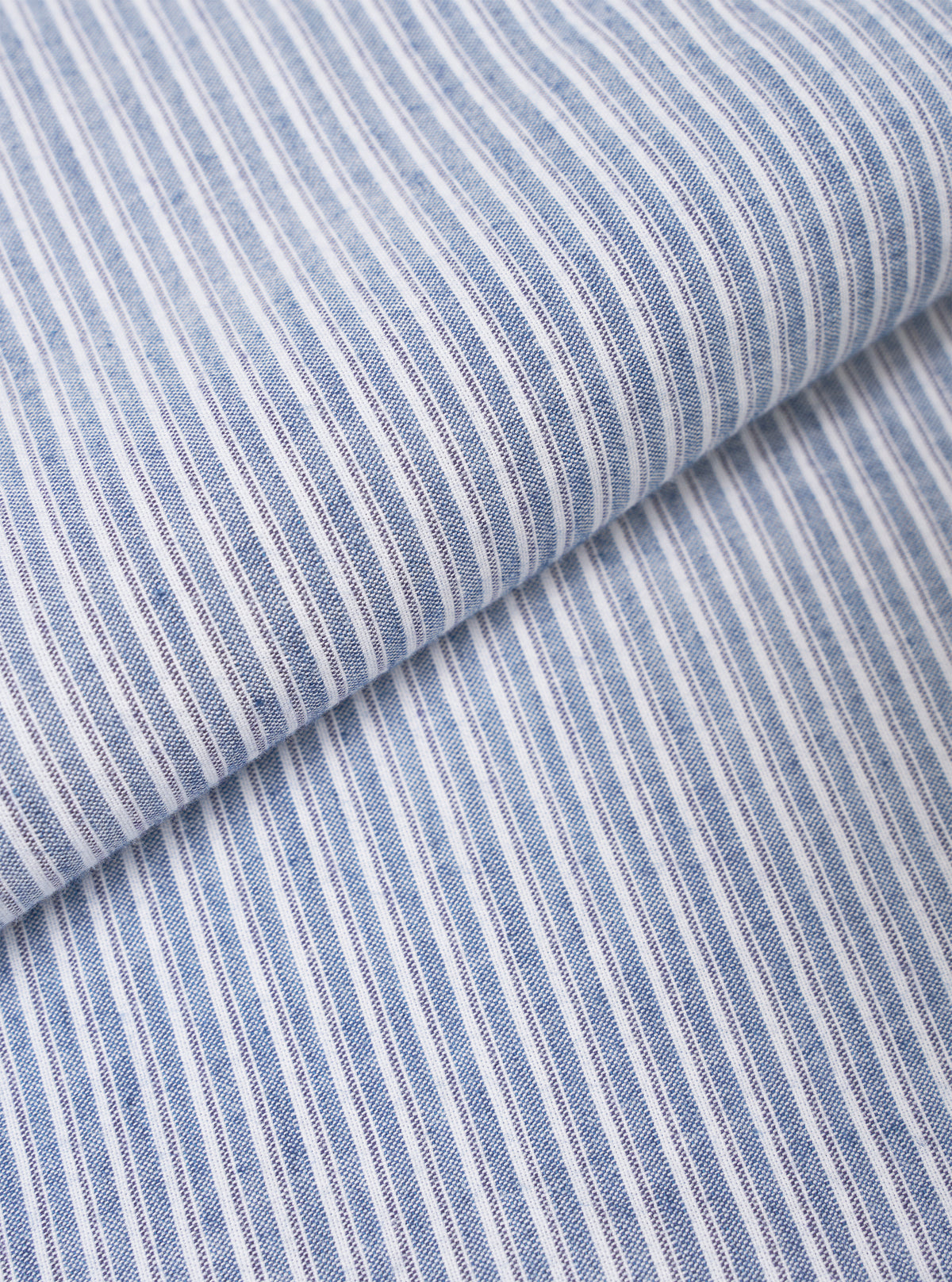 Close-up fabric swatch image detailing the fine texture and pattern of the Blue Montgomery Stripe Station Shirt. The image fills the frame to show the woven cotton fabric, distinct blue and light stripe structure, and smooth material weave.
