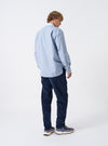 A male model wears the Mix Stripes WM Station Shirt in a three-quarter side pose against a plain studio background. The shot highlights the contrast striped cotton panels, buttoned cuffs, chest pocket detail, and casual styling of the shirt.