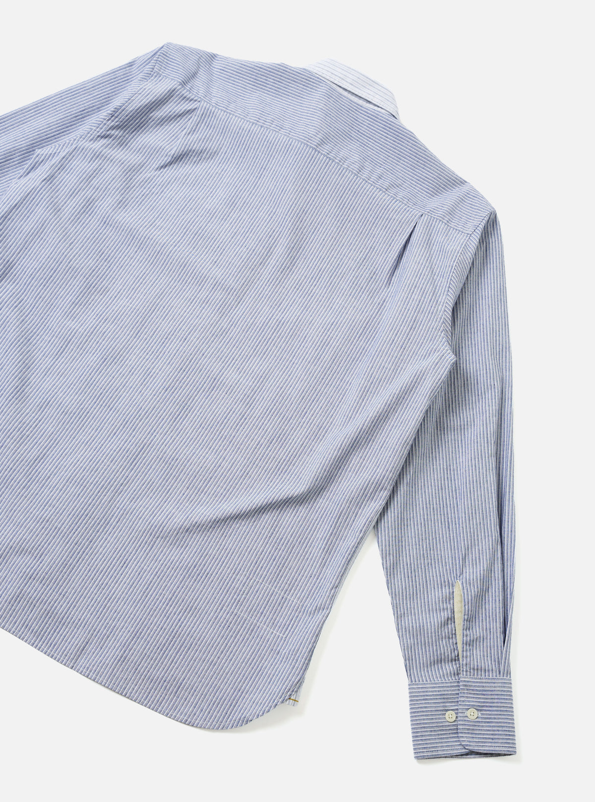 Back view of the Mix Stripes WM Station Shirt presented against a clean plain background. The shot displays the varying stripe orientation across the back yoke and body, structured shoulder seams, straight lower hem, and cotton fabric texture.