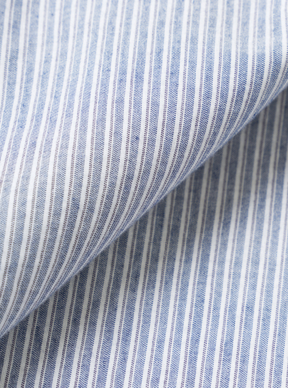 A close-up fabric swatch view of the Mix Stripes WM Station Shirt filling the frame. The image highlights the texture and contrasting woven blue and navy stripe patterns of the lightweight cotton material.