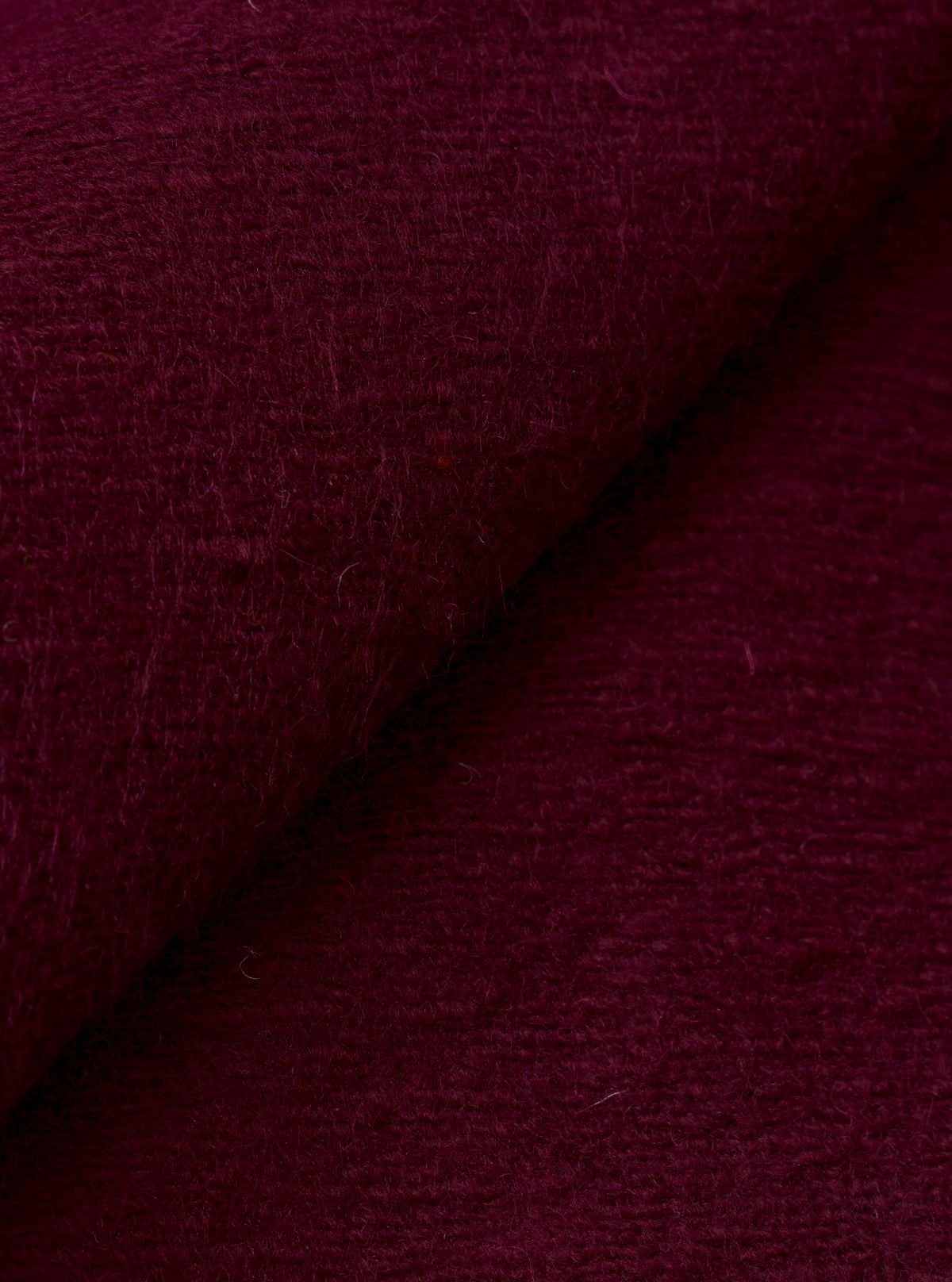 A close-up fabric swatch view showing the textured weave and soft brushed finish of the Dark Red Dam Marl Work Shirt. The detailed image fills the frame to emphasize the rich dark red marl fleece fabric.