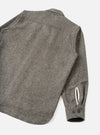 An angled side view of the Mid Brown Dam Marl Work Shirt against a neutral white backdrop. The photo highlights the sleeve placket details, button cuffs, and rich brown heathered wool-blend material.