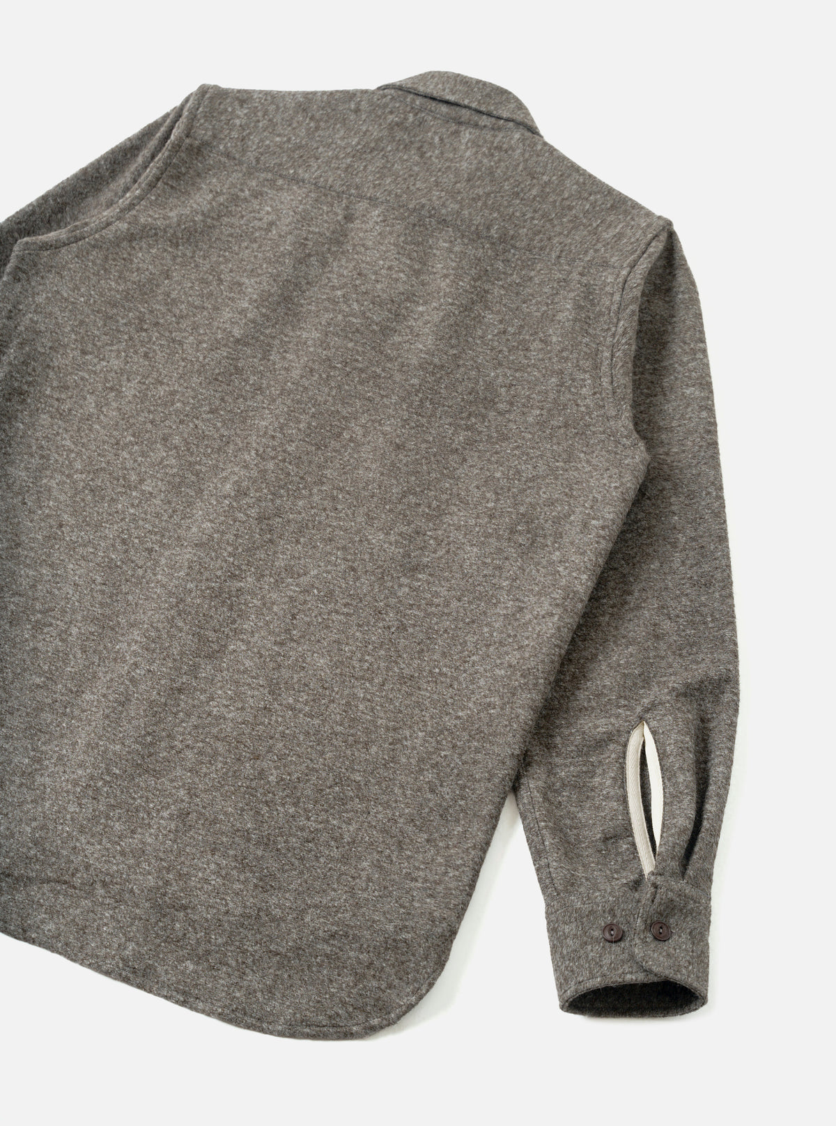 An angled side view of the Mid Brown Dam Marl Work Shirt against a neutral white backdrop. The photo highlights the sleeve placket details, button cuffs, and rich brown heathered wool-blend material.