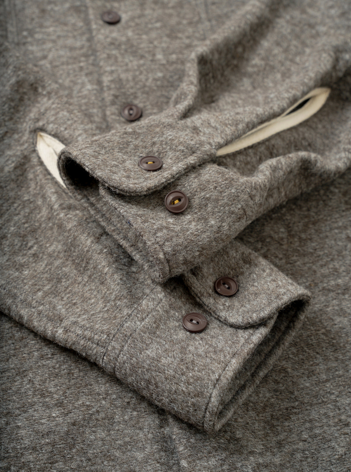 A detailed rear view of the Mid Brown Dam Marl Work Shirt set against a clean white background. The image highlights the smooth back yoke seam, straight hem finish, and brushed marl fabric texture.
