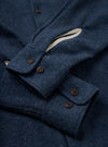 A back view of the Navy Dam Marl Work Shirt displayed flat against a plain white background. The shot highlights the clean back yoke seam construction, subtle curved hem, and soft marl finish.