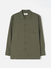 Front view of the Olive Slub Sateen Fatigue Shirt set against a plain white background. The shot highlights the chest flap pockets, button-down front closure, and olive green cotton sateen material.