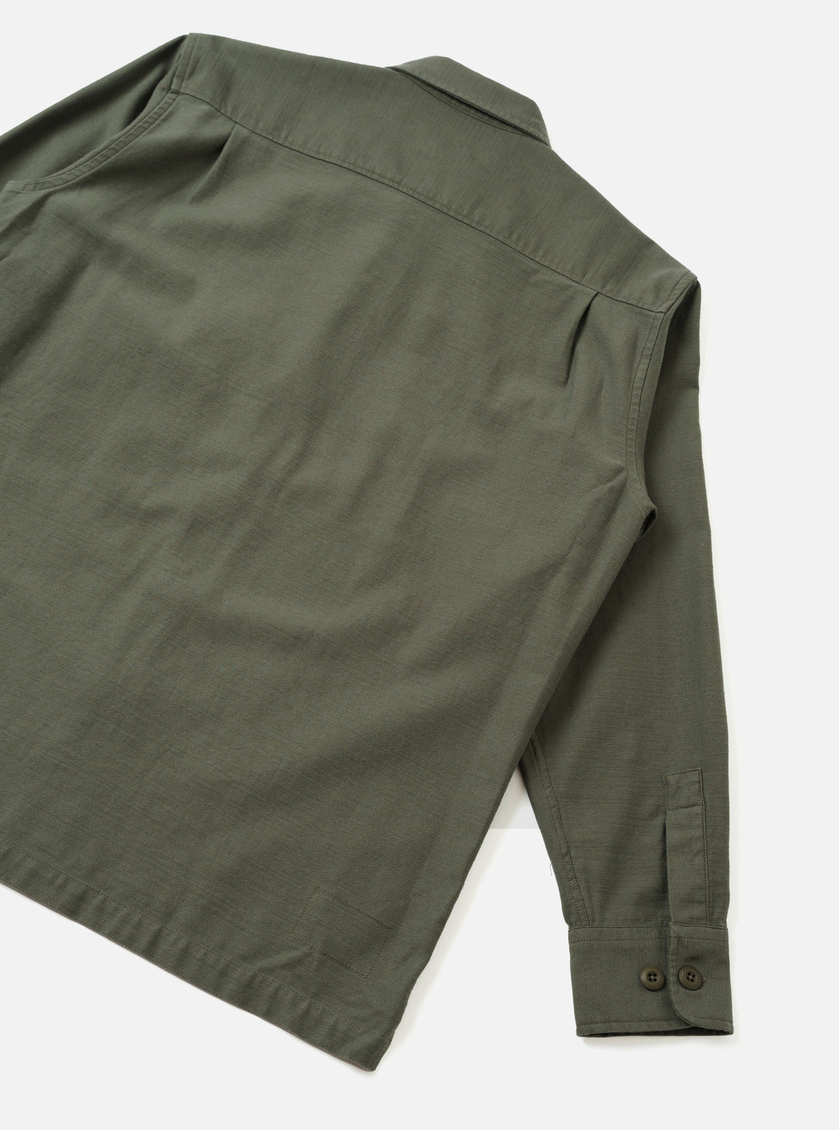Back view of the Olive Slub Sateen Fatigue Shirt presented against a clean off-white background. The image details the rear shoulder yoke, straight hemline, and durable olive fabric construction.