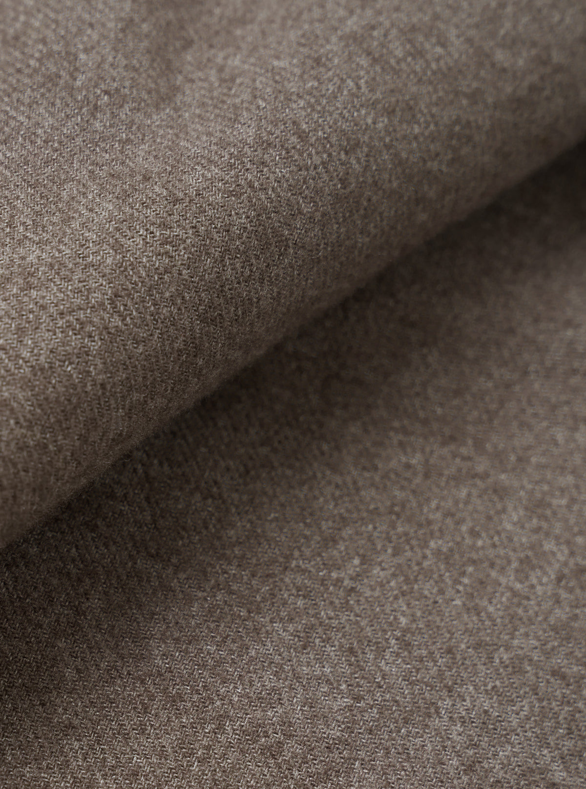 A close-up fabric swatch view filling the entire frame to demonstrate the rich texture, fine weave, and deep brown color of the material used in the Brown Monty Cotton Tencel Zip Shirt.