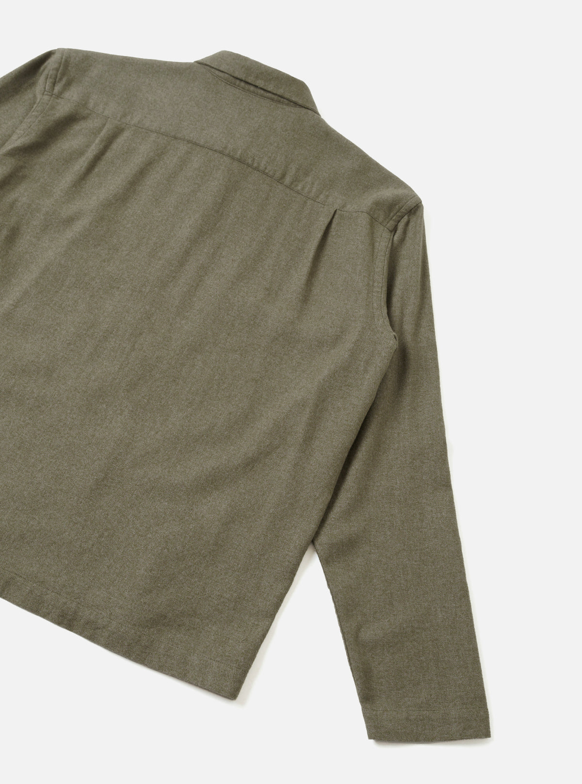 A clear back view of the Olive Monty Cotton Tencel Zip Shirt set against a plain white studio background, highlighting the smooth back panel, shoulder seams, and straight hem construction.