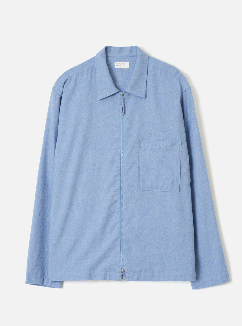 A front view of the Sky Blue Monty Cotton Tencel Zip Shirt against a plain off-white studio background, showcasing the neat collar, front zip closure, chest pocket, and light blue tone.