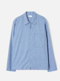 A front view of the Sky Blue Monty Cotton Tencel Zip Shirt against a plain off-white studio background, showcasing the neat collar, front zip closure, chest pocket, and light blue tone.