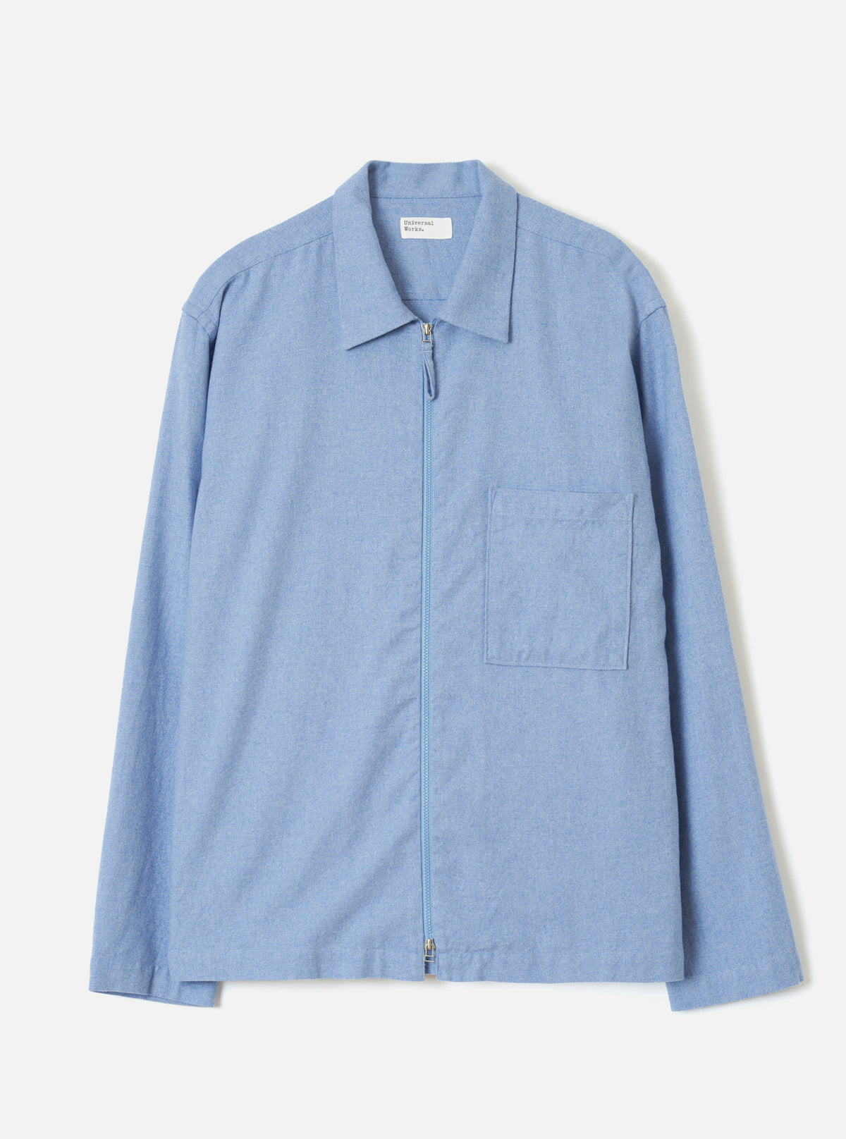 A front view of the Sky Blue Monty Cotton Tencel Zip Shirt against a plain off-white studio background, showcasing the neat collar, front zip closure, chest pocket, and light blue tone.