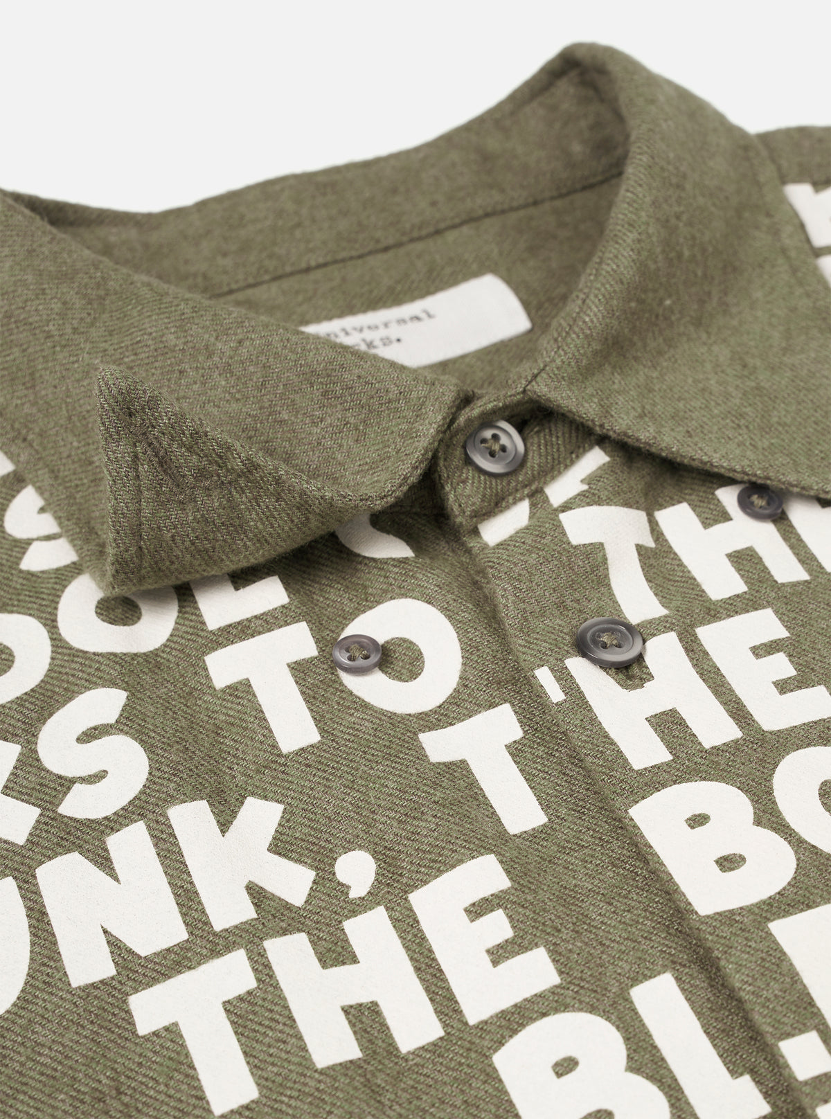 Close-up detail view of the Olive Monty Cotton Tencel Standard Shirt on a white background, showing the buttoned cuff, sleeve slit detail, and soft cotton-tencel material texture.