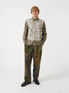 A male model wears the Olive Monty Cotton Tencel Standard Shirt fully buttoned up, standing in a studio setting against a plain background, demonstrating the classic fit and drape.