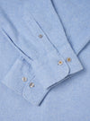 A back view of the Sky Blue Monty Cotton Tencel Standard Shirt presented against a clean off-white background. The shot highlights the smooth back panel, shoulder yoke, neat hemline, and light blue fabric texture.