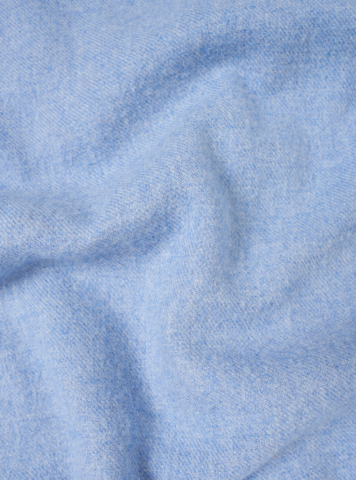 A detailed close-up fabric swatch image showing the soft texture and subtle weave of the Sky Blue Monty Cotton Tencel Standard Shirt. The shot fills the frame to highlight the light blue material quality.