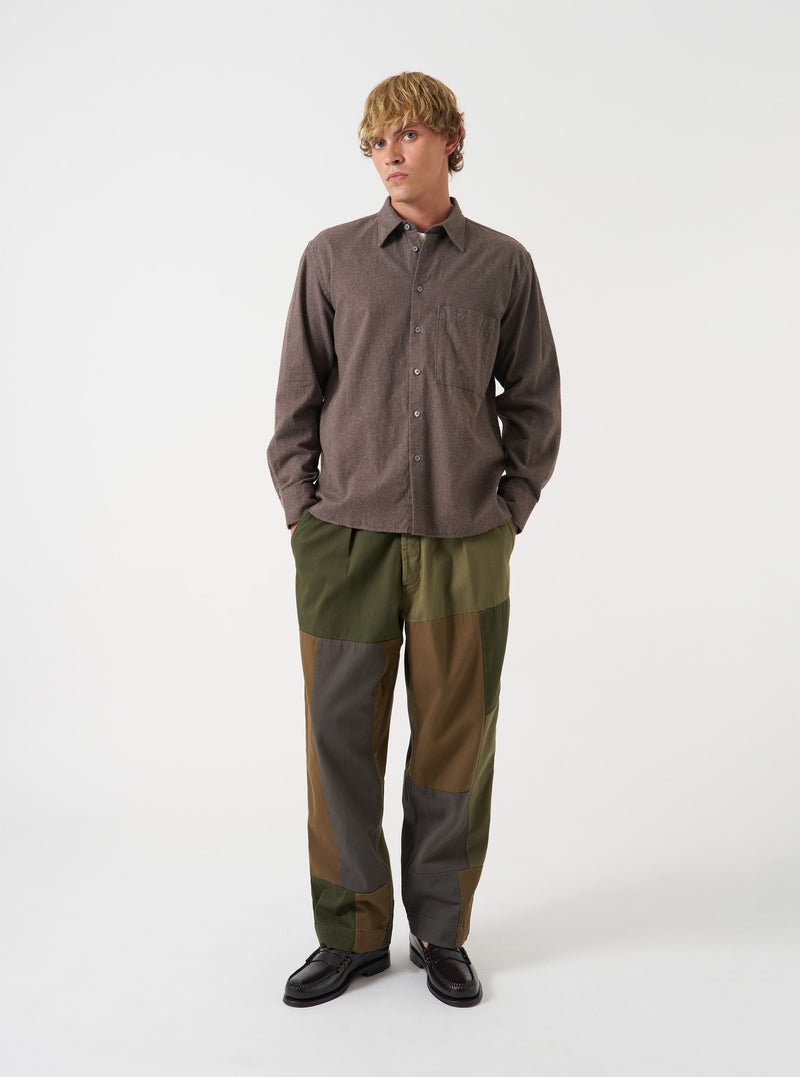 A male model stands against a plain off-white studio background wearing the Brown Brushed Flannel Square Pocket Shirt. The front-facing image highlights the buttoned placket, classic collar, and square chest pockets.