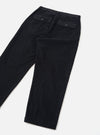 Black corduroy grad chino trousers laid flat on a light grey surface, showing the back. Fine-wale cord texture throughout. Two large patch pockets with flap closures and single metal press-stud buttons sit at the waistband. Tapered leg with full-length hem visible at the cuff.