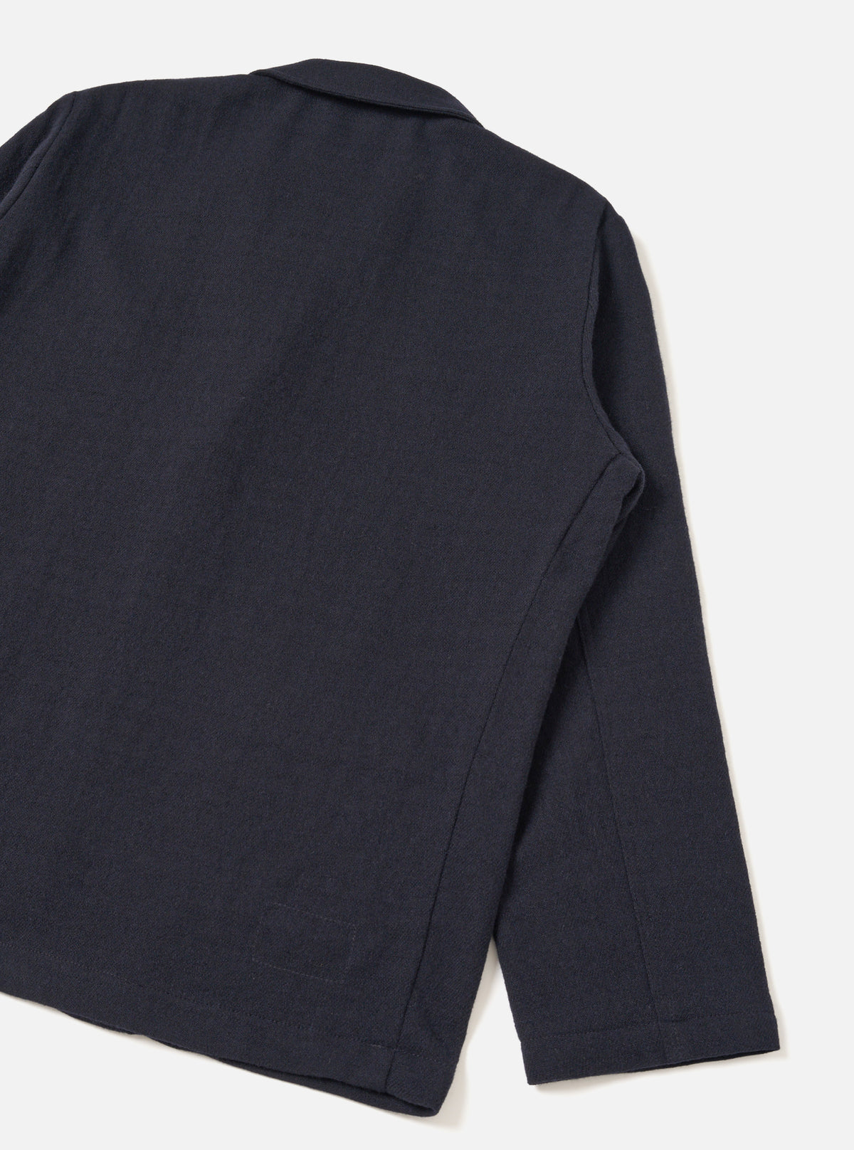 A detailed back view of the Dark Navy Robin Wool Mix Two Button Jacket presented against a plain off-white studio background, highlighting the clean rear hem, subtle shoulder construction, and textured wool-blend fabric.
