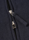 A male model wears the Dark Navy Robin Wool Mix Club Jacket zipped up, standing against a neutral studio backdrop, illustrating the jacket's loose fit, adjustable hem, and smart-casual aesthetic.