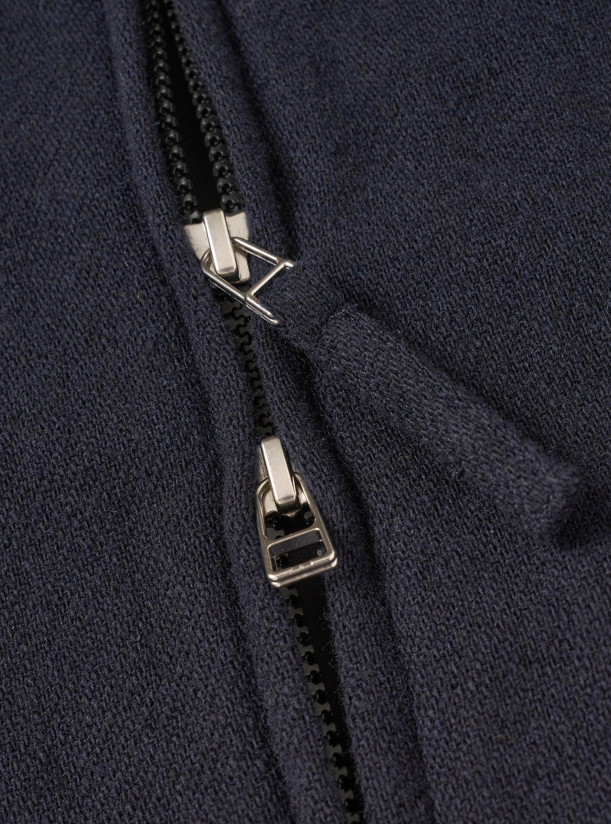 A male model wears the Dark Navy Robin Wool Mix Club Jacket zipped up, standing against a neutral studio backdrop, illustrating the jacket's loose fit, adjustable hem, and smart-casual aesthetic.
