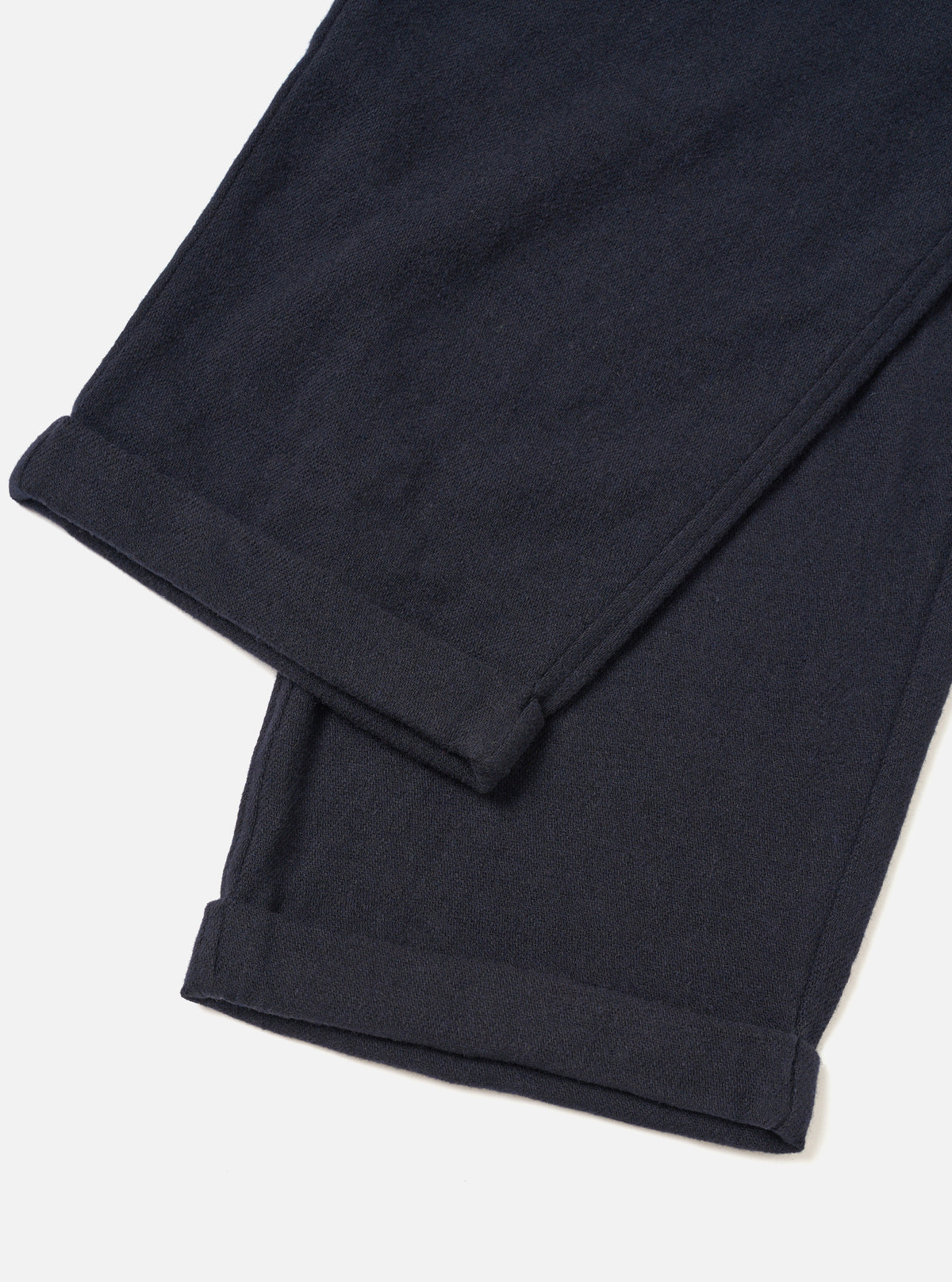 A male model wears the Dark Navy Robin Wool Mix Lindberg Pant in an angled pose against a white studio background, illustrating how the trousers drape and fit around the waist and legs.
