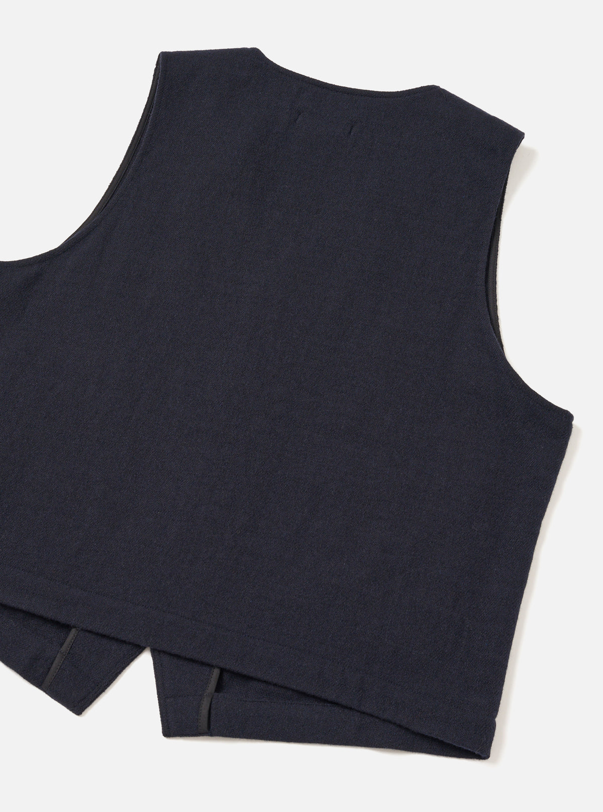 Back view of the Dark Navy Robin Wool Mix JJ Waistcoat set against a clean studio background, showing the unlined back panel made from the same dark navy wool-blend fabric and clean hemline.