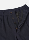 A detailed close-up shot of the Dark Navy Robin Wool Mix Pleated Track Pant waistband on a plain background, highlighting the front single pleat, drawstring closure, and fine fabric texture.