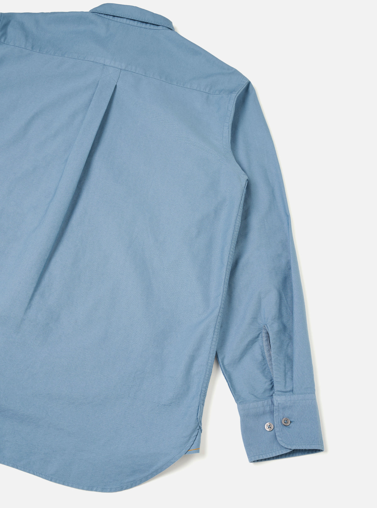 Back view of the Mid Blue R.Oxford Lazy Day Shirt shown against a plain studio background, detailing the clean shoulders, structured back yoke, and box pleat for comfortable, easy movement.