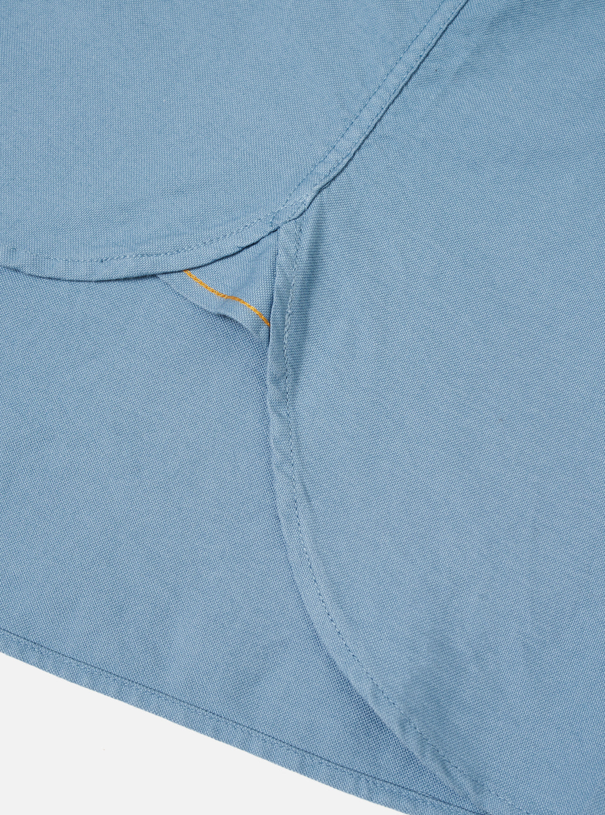A male model wears the Mid Blue R.Oxford Lazy Day Shirt in a full-body pose against a plain white studio backdrop, showcasing how the shirt pairs with casual trousers for a laid-back look.