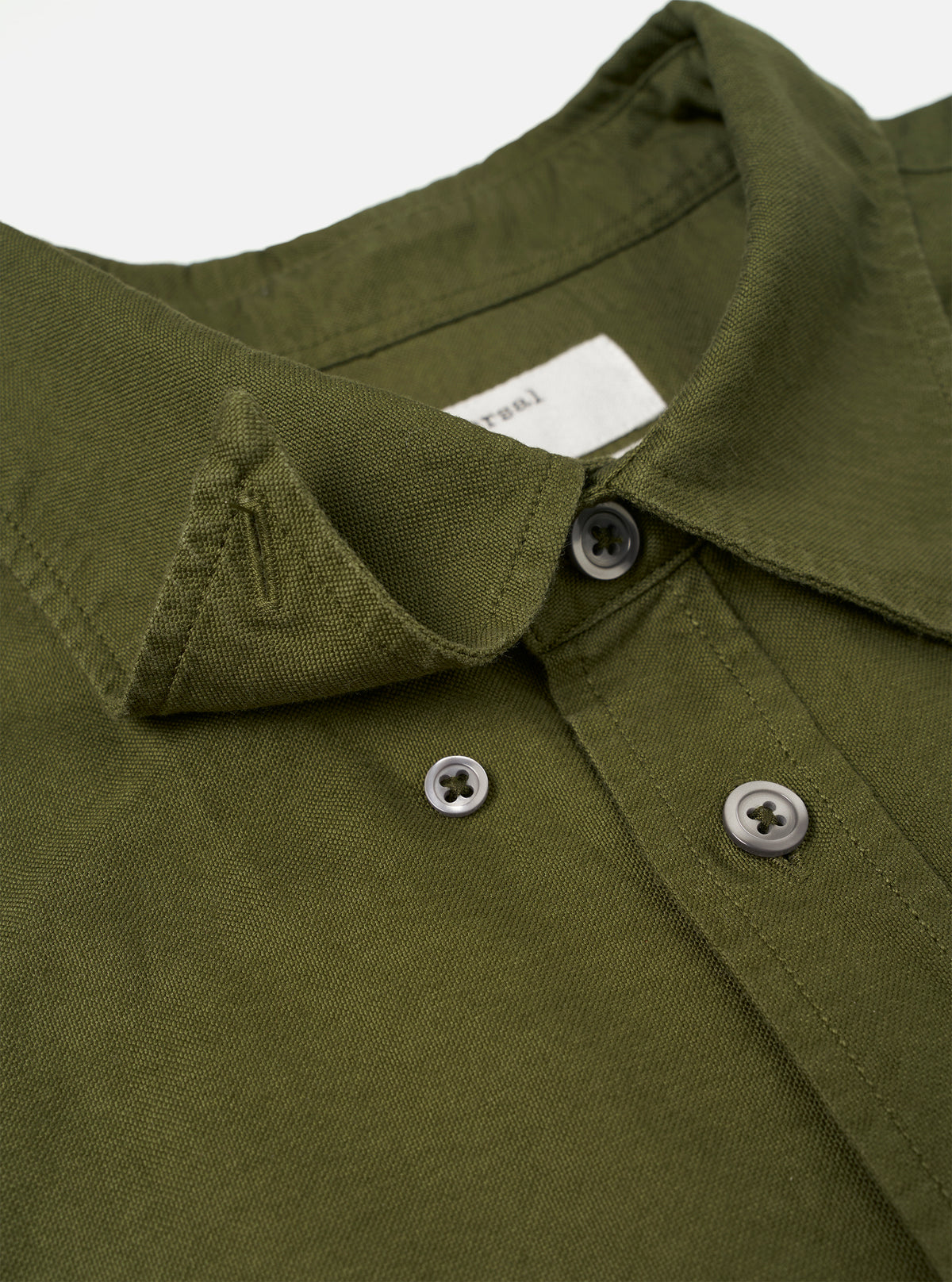 A full-length shot of a male model wearing the Olive R.Oxford Lazy Day Shirt paired with casual trousers against a studio background, illustrating the versatile smart-casual aesthetic.