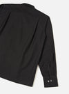 Back view of the Black R.Oxford Lucky Shirt set against a plain studio background, highlighting the straight hem, shoulder seam construction, and deep black Oxford cotton fabric.