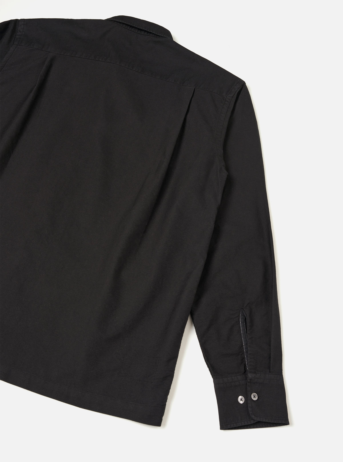 Back view of the Black R.Oxford Lucky Shirt set against a plain studio background, highlighting the straight hem, shoulder seam construction, and deep black Oxford cotton fabric.