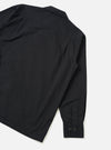 Rear view of the Black Slub Shirting Fatigue Shirt presented on a solid off-white background. The shot highlights the smooth back panel, clean hemline, straight shoulder seams, and slub texture of the cotton fabric.