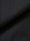 A full-frame fabric swatch image detailing the rich texture and weave of the Black Slub Shirting Fatigue Shirt. The macro shot highlights the subtle slub cotton pattern and dark tone of the material up close.